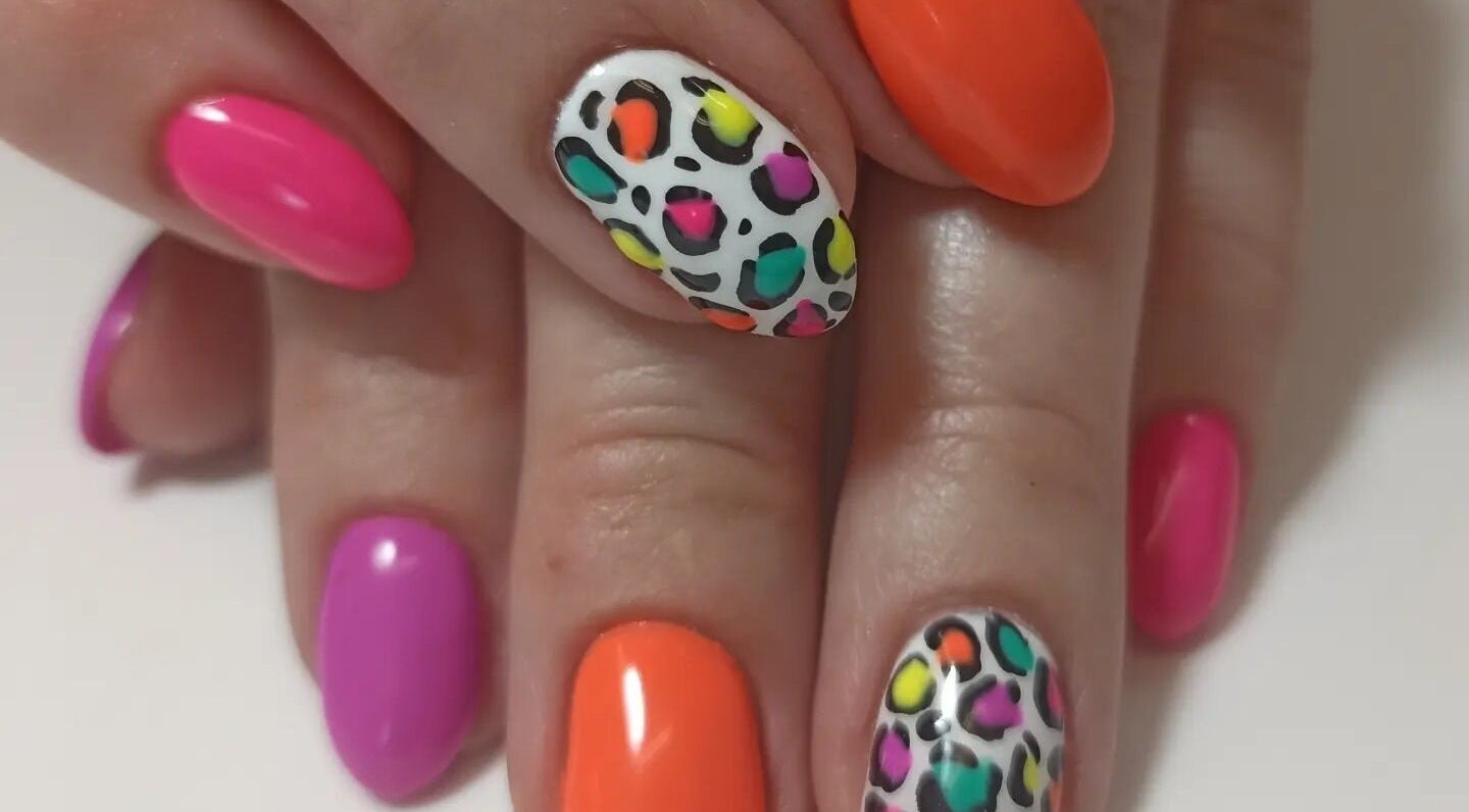 Colorful leopard print nails at Tranquility C Salon in Krugersdorp, Gauteng, ZA, showcasing vibrant nail art.