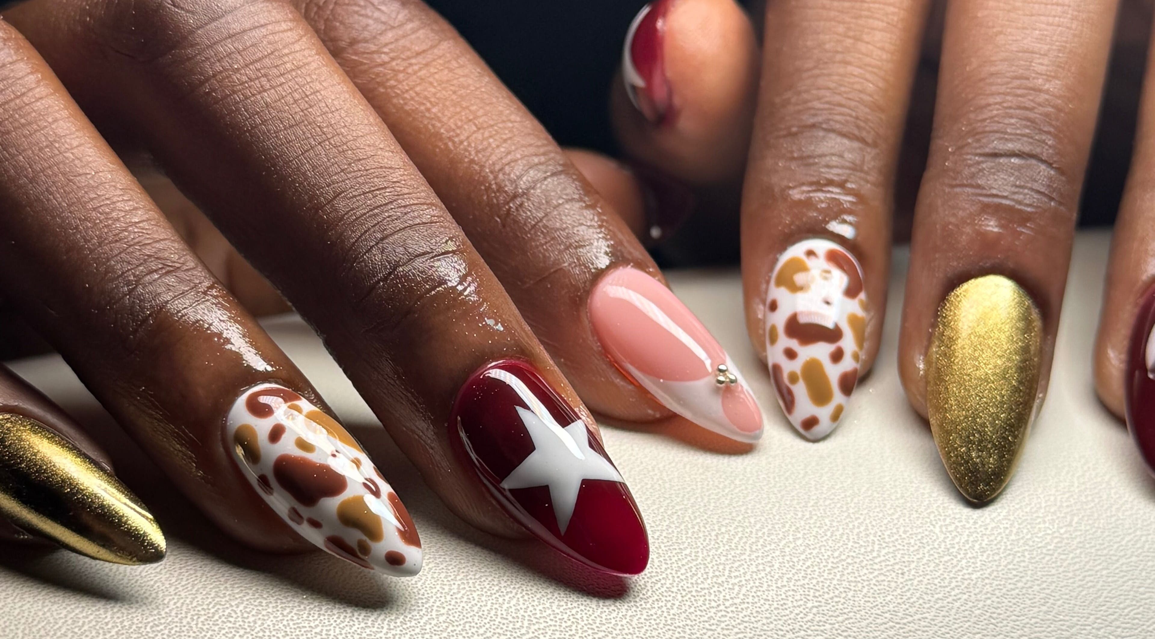Elegant nail art at The Nail Place Ja in Kingston, St. Andrew Parish, JM showcasing vibrant designs and gold sheen.