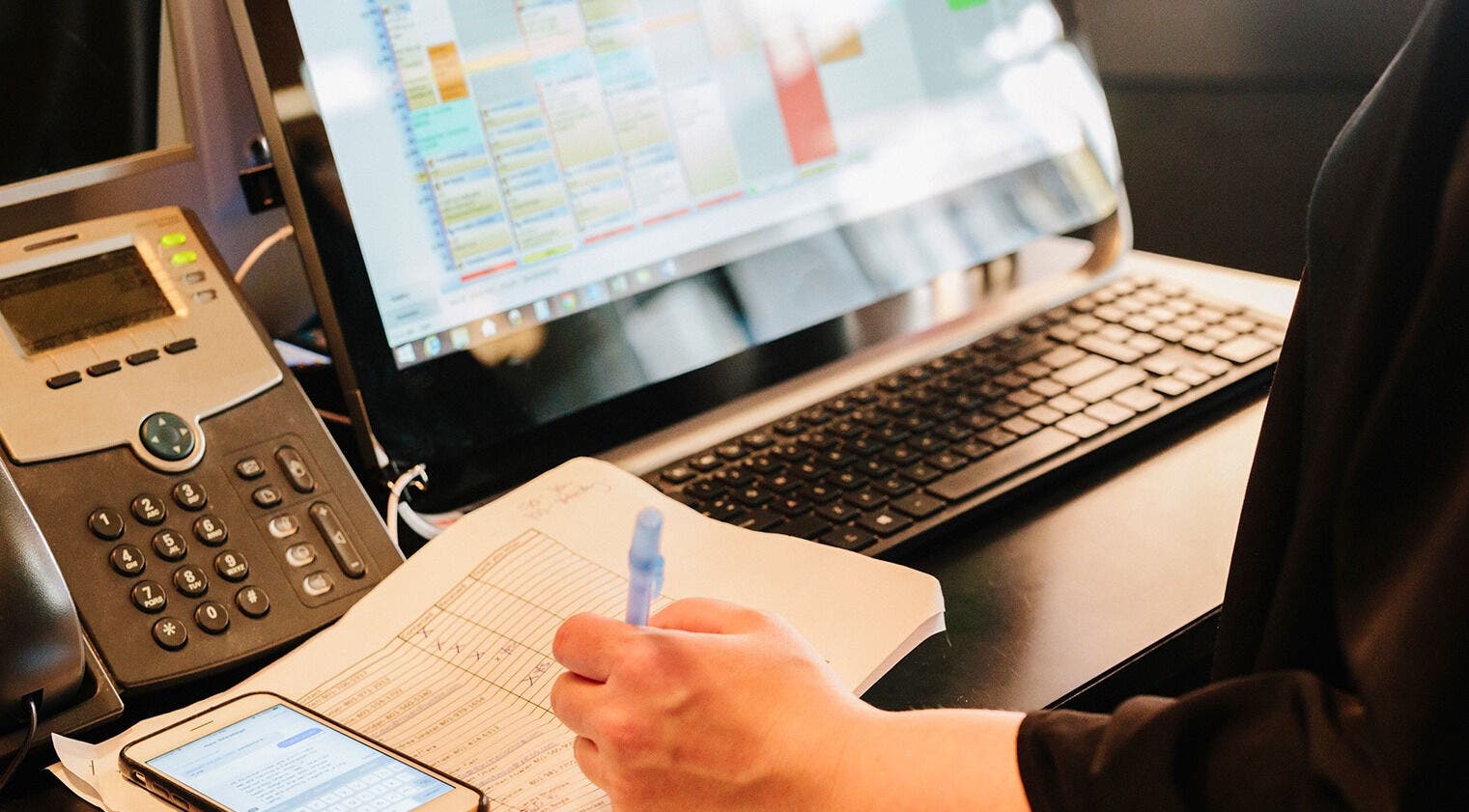 Staff managing appointments at Hair 'n Balance Studio, Paramaribo, SR on a computer.