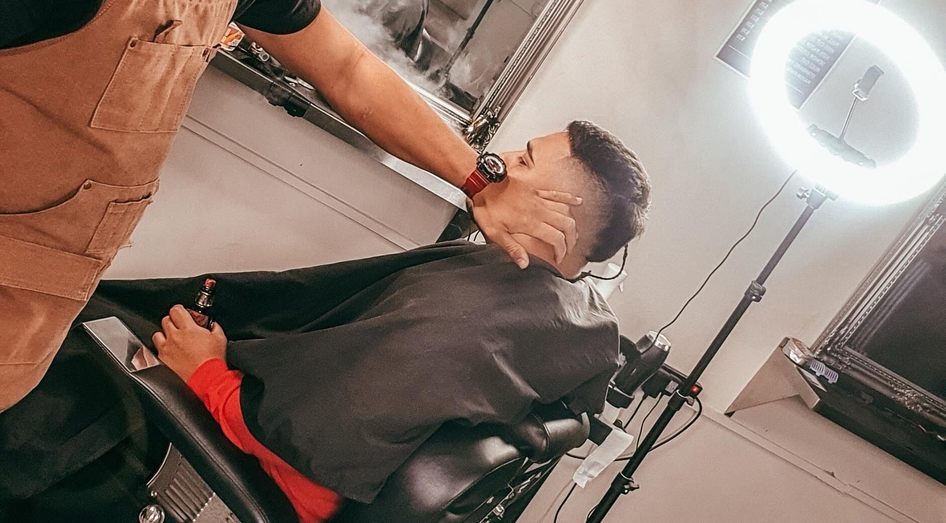Barber crafting a fresh haircut at Tapslab, Tokoroa, Waikato, NZ under professional lighting.