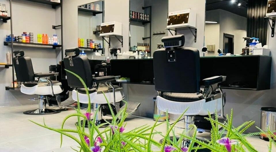 Modern interior of Bab Elanaka Barbershop - باب الأناقة للحلاقة in Riyadh, Riyadh Province, SA with stylish chairs.