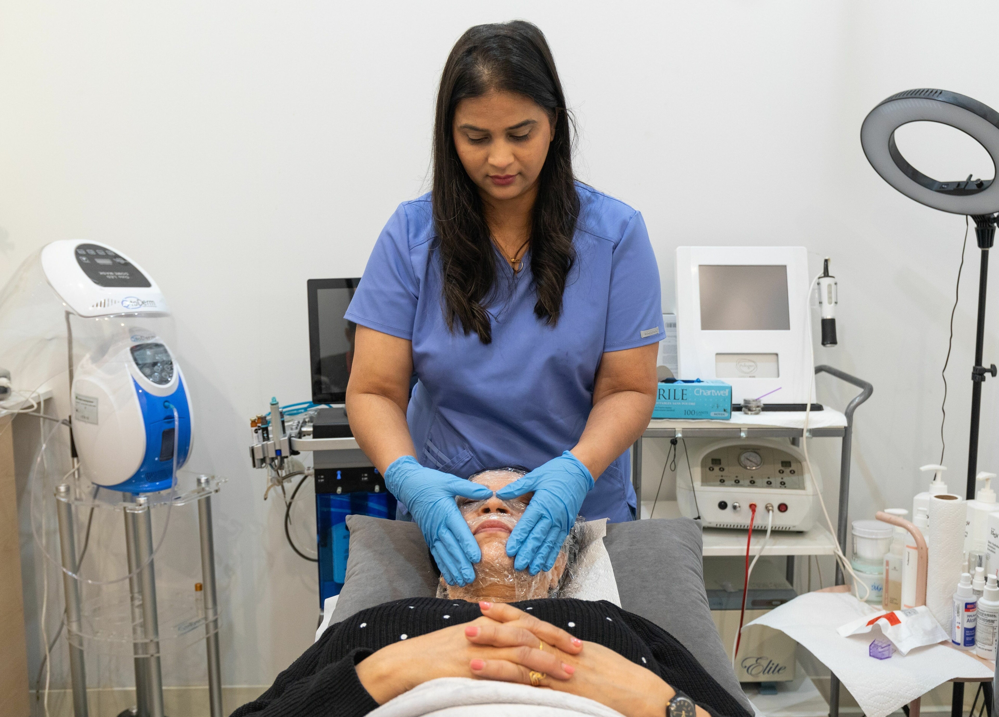 Aesthetician at Best Brow Spa in Vancouver, British Columbia, CA, performing a facial treatment on a client.