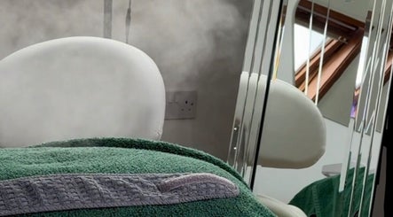 Luxurious spa room at Natural Beauty Cardiff in Cardiff, Wales, GB, featuring a steaming treatment bed.
