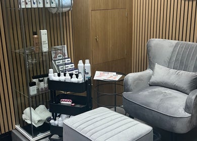 Elegant seating area in Krystle Beauty, Swalwell, England, GB with plush chair and displayed products.