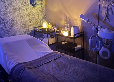 Relaxing treatment room at Krystle Beauty, Swalwell, England, GB with massage bed and ambient lighting.