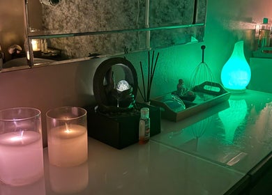 Relaxing candles and green lighting at Krystle Beauty, Swalwell, England, GB, creating a soothing atmosphere.