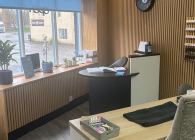 Modern salon interior at Krystle Beauty, Swalwell, England, GB with sleek wooden decor and natural light.