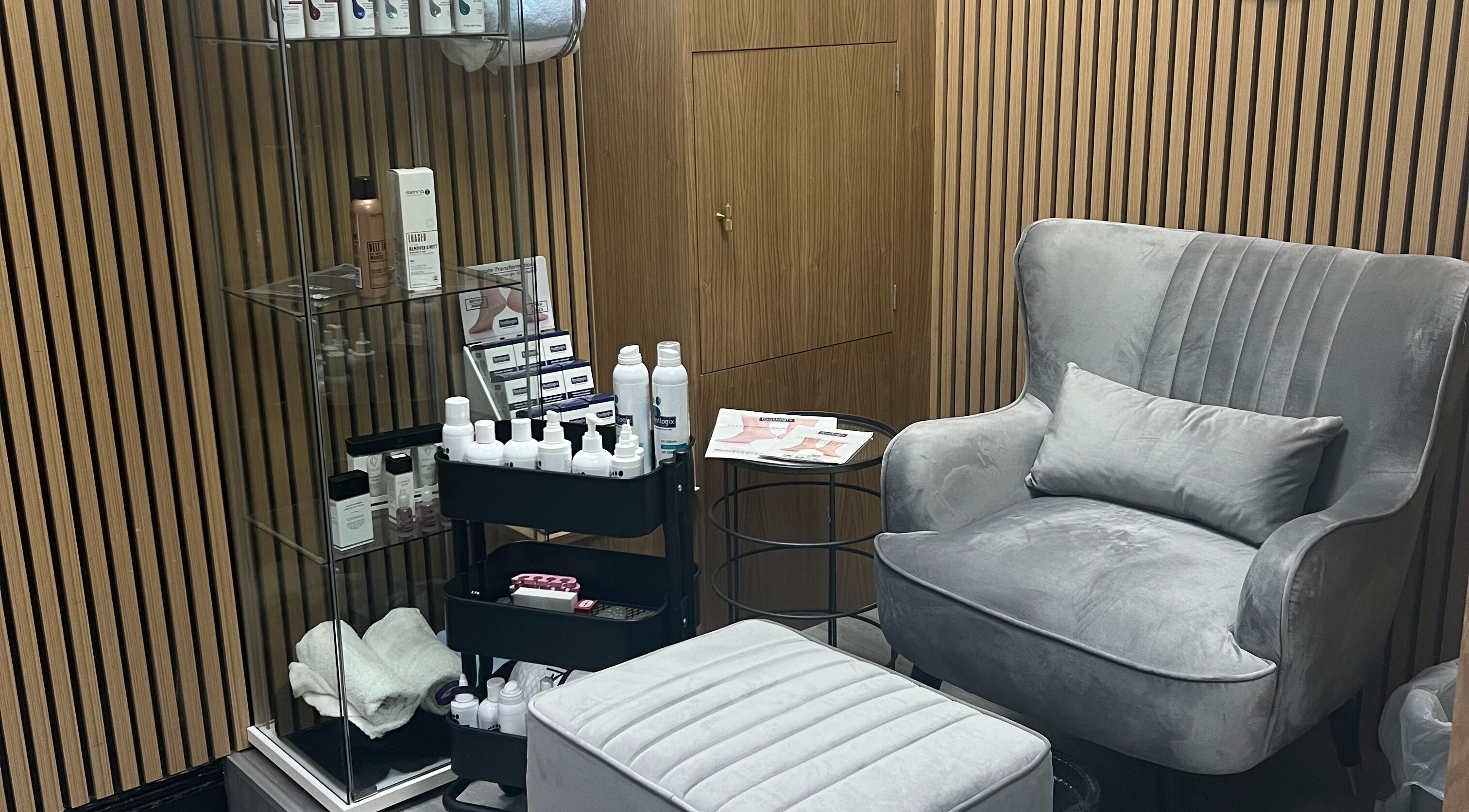 Elegant treatment room at Krystle Beauty, Swalwell, England featuring plush seating and skincare products.
