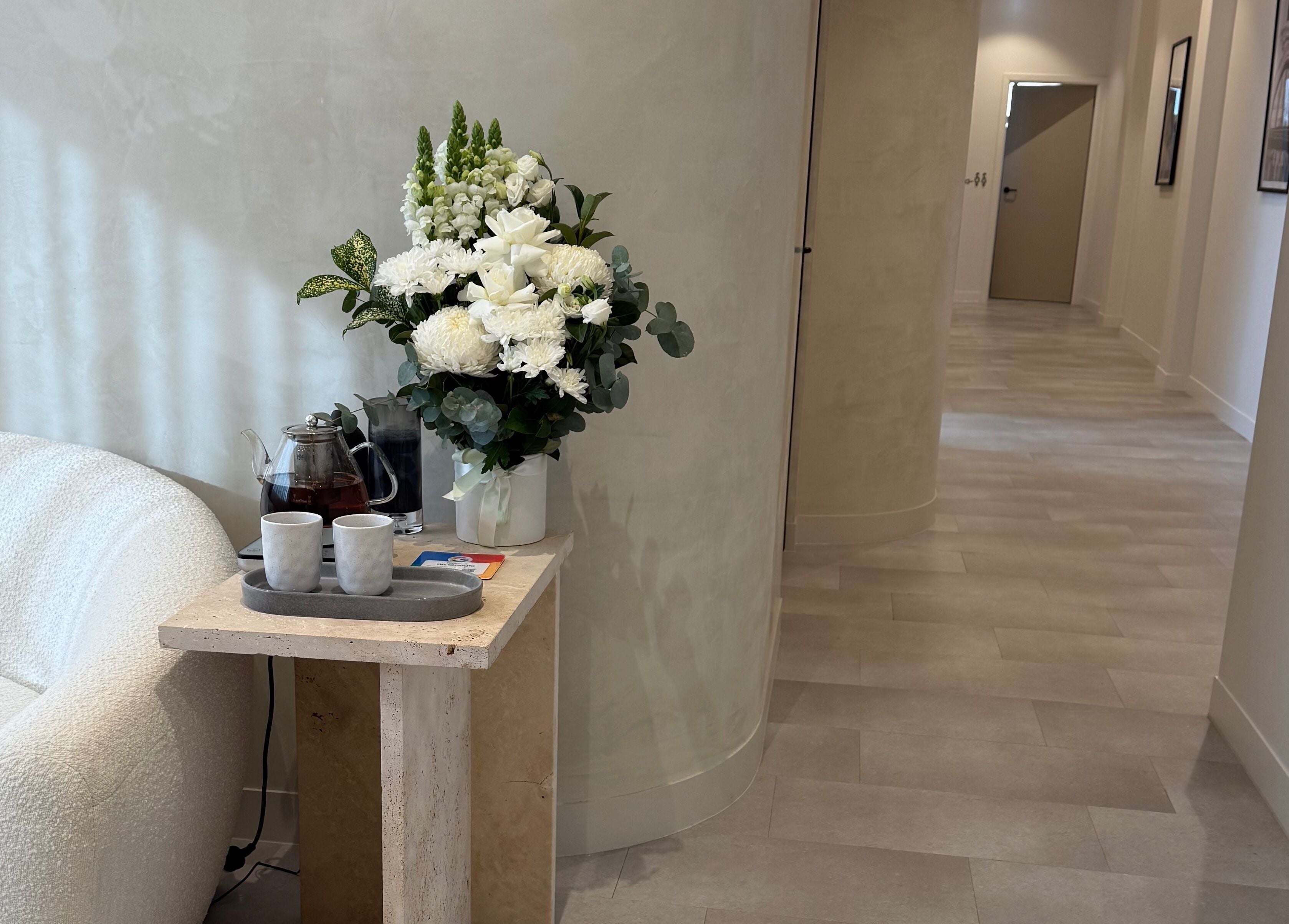 Elegant lounge with flowers at EMBER Aesthetics, Mosman, New South Wales, AU.