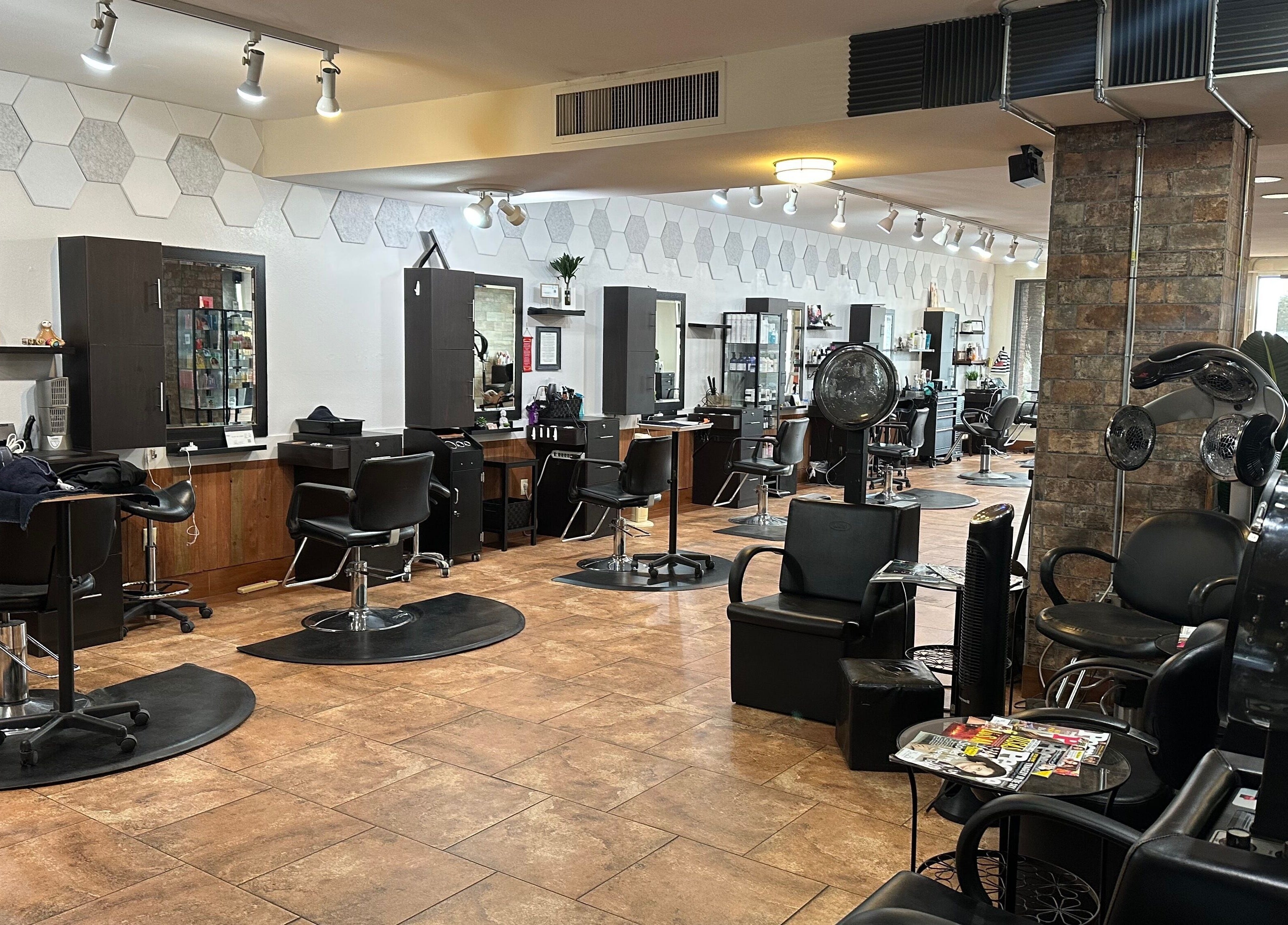 Modern salon interior at Refreshed Looks Aesthetics in Tucson, Arizona, US featuring stylish black chairs and mirrors.