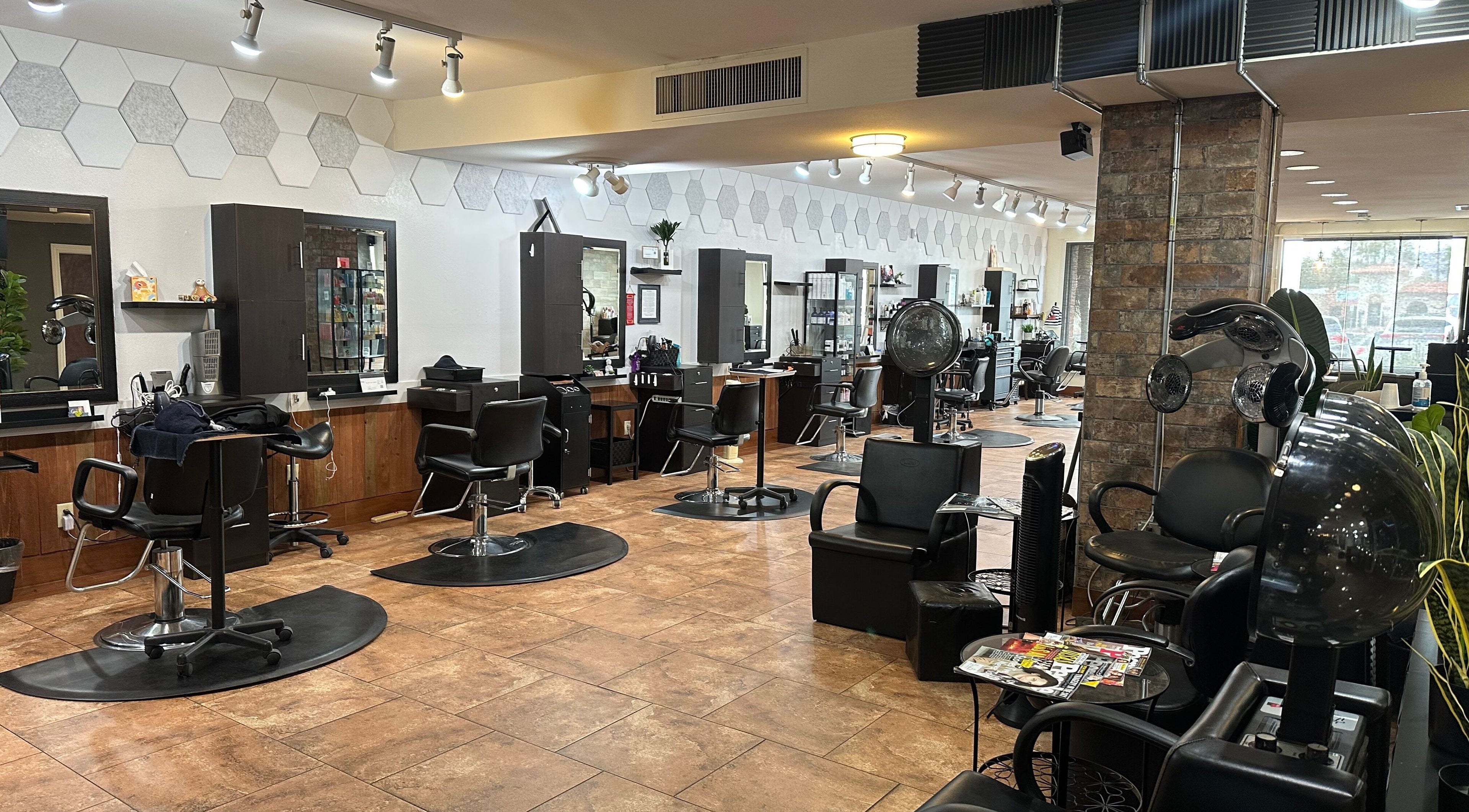 Modern salon interior at Refreshed Looks Aesthetics in Tucson, Arizona, US featuring stylish black chairs and mirrors.