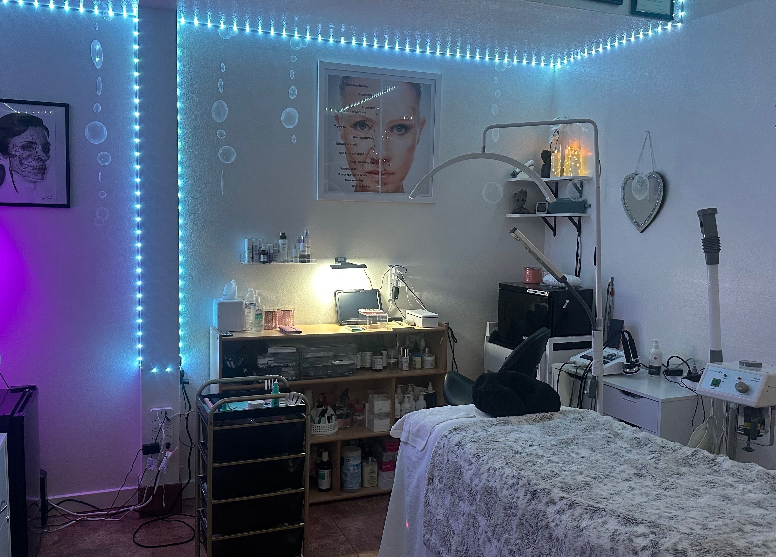 Tranquil treatment room at Refreshed Looks Aesthetics, Tucson, Arizona, US, featuring ambient lighting and cozy decor.
