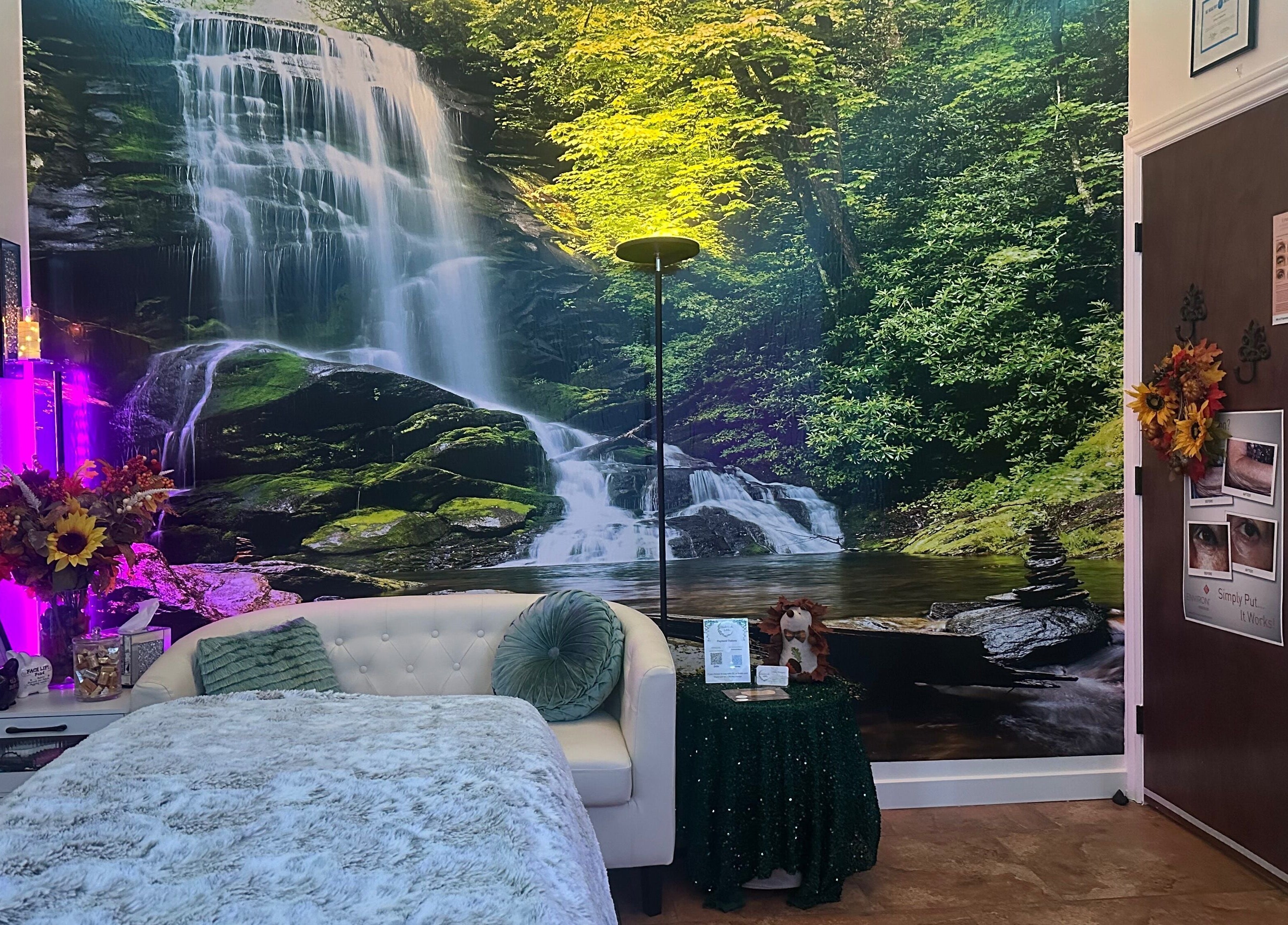Tranquil spa room at Refreshed Looks Aesthetics in Tucson, Arizona, US with waterfall mural and cozy decor.
