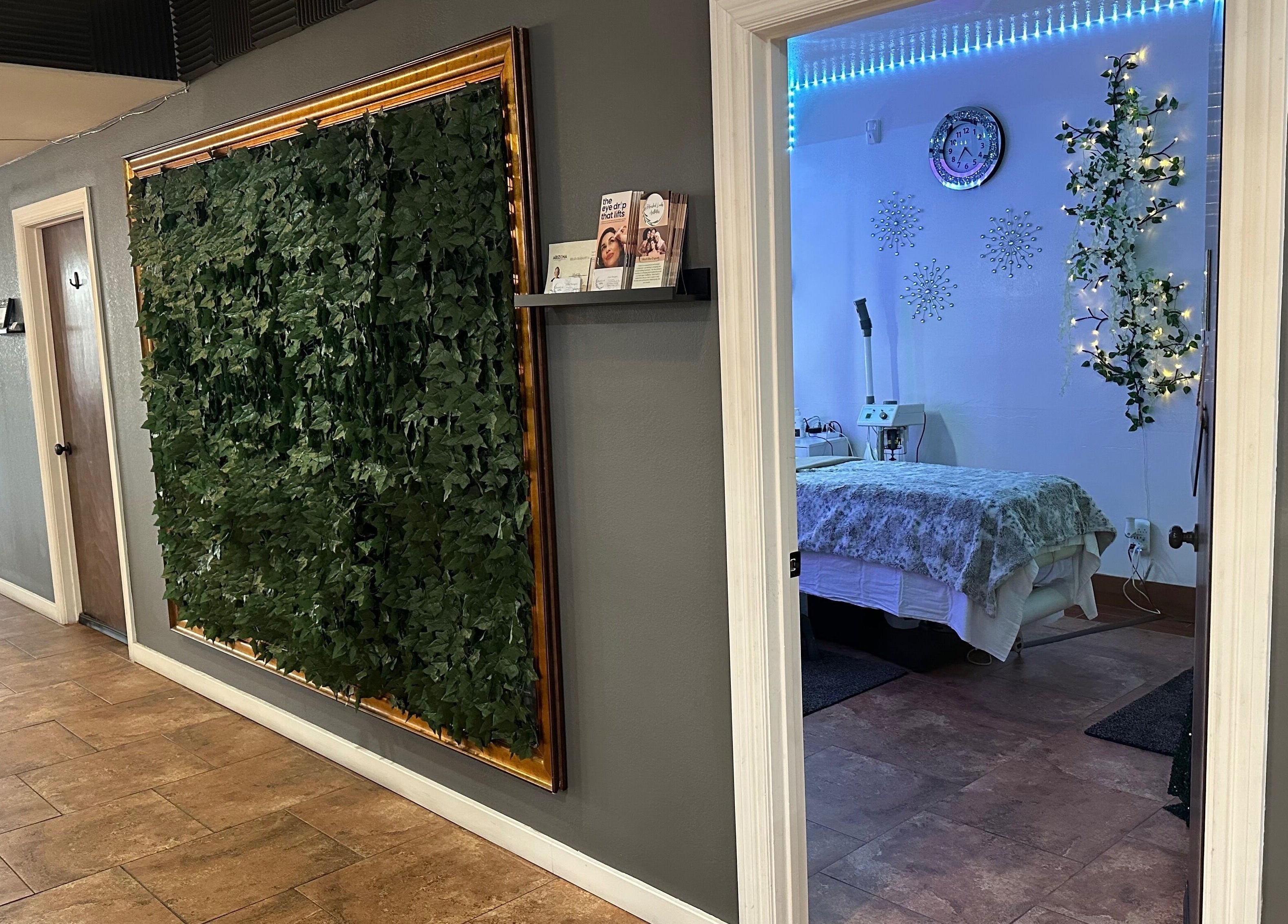 Entrance to a tranquil treatment room at Refreshed Looks Aesthetics, Tucson, Arizona, US, with greenery decor.