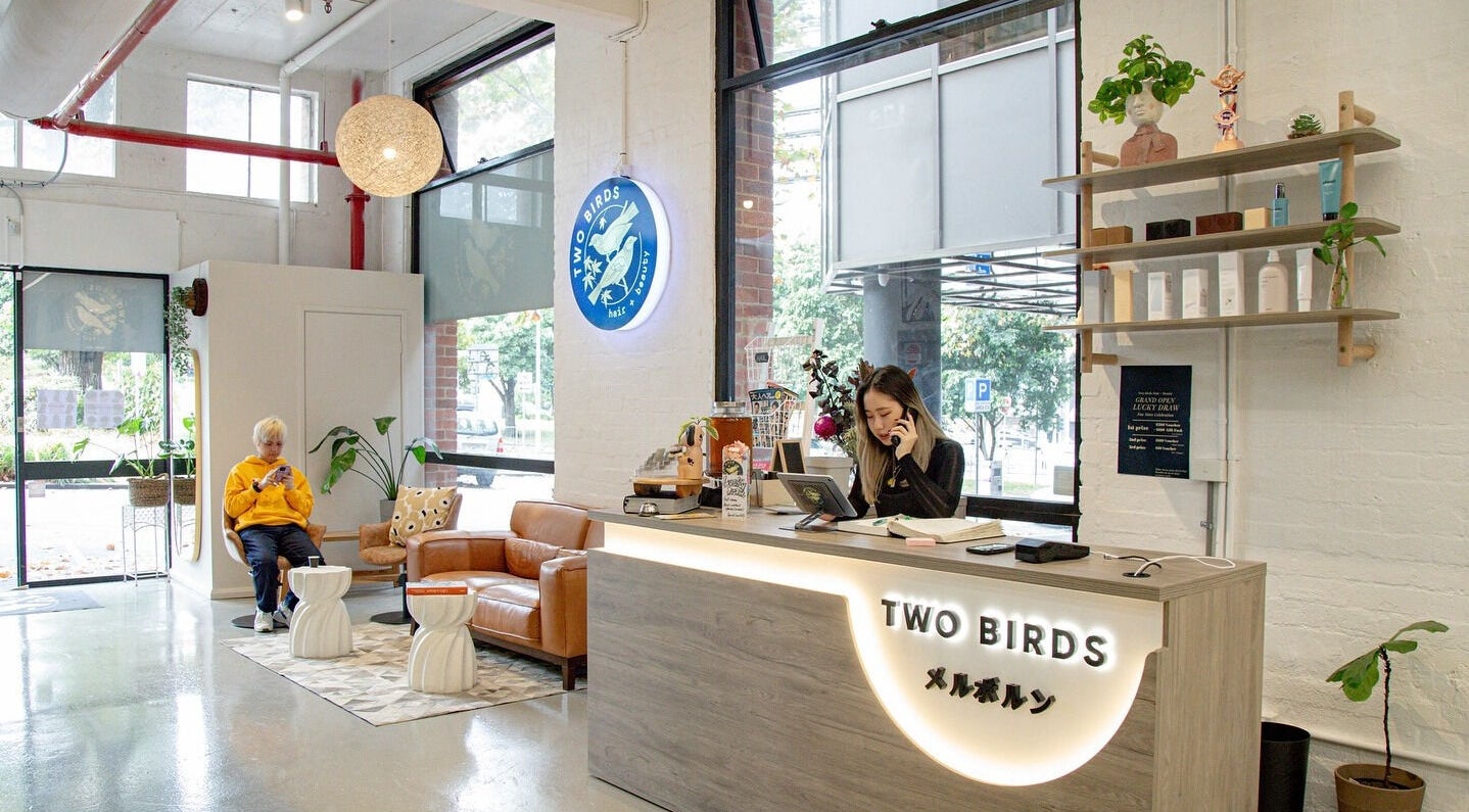 Reception area of Two Birds Hair and Beauty Salon in Melbourne, Victoria, AU, showing a chic modern decor.