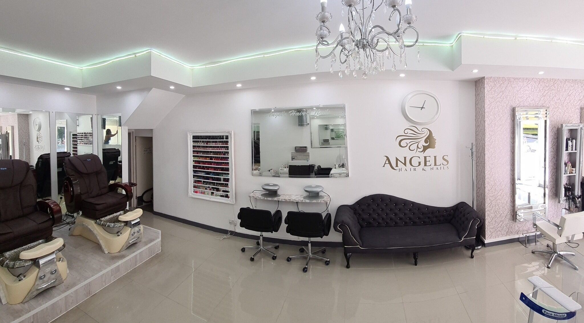 Chic interior of Angel's Hair and Nails in London, England, GB, showcasing stylish seating and decor.