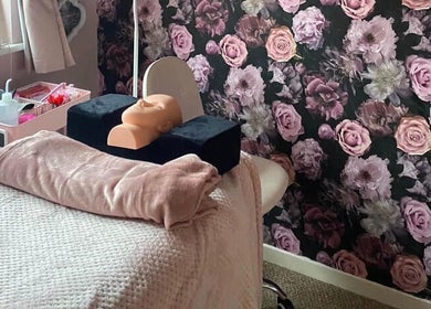 A serene treatment room at Halo Hair & Beauty in Nuneaton, England, GB, with floral decor and cozy setup.