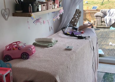 A charming interior at Halo Hair & Beauty in Nuneaton, England, GB, with decor and a pink toy car.
