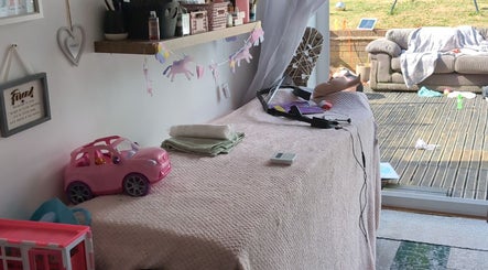 A charming interior at Halo Hair & Beauty in Nuneaton, England, GB, with decor and a pink toy car.