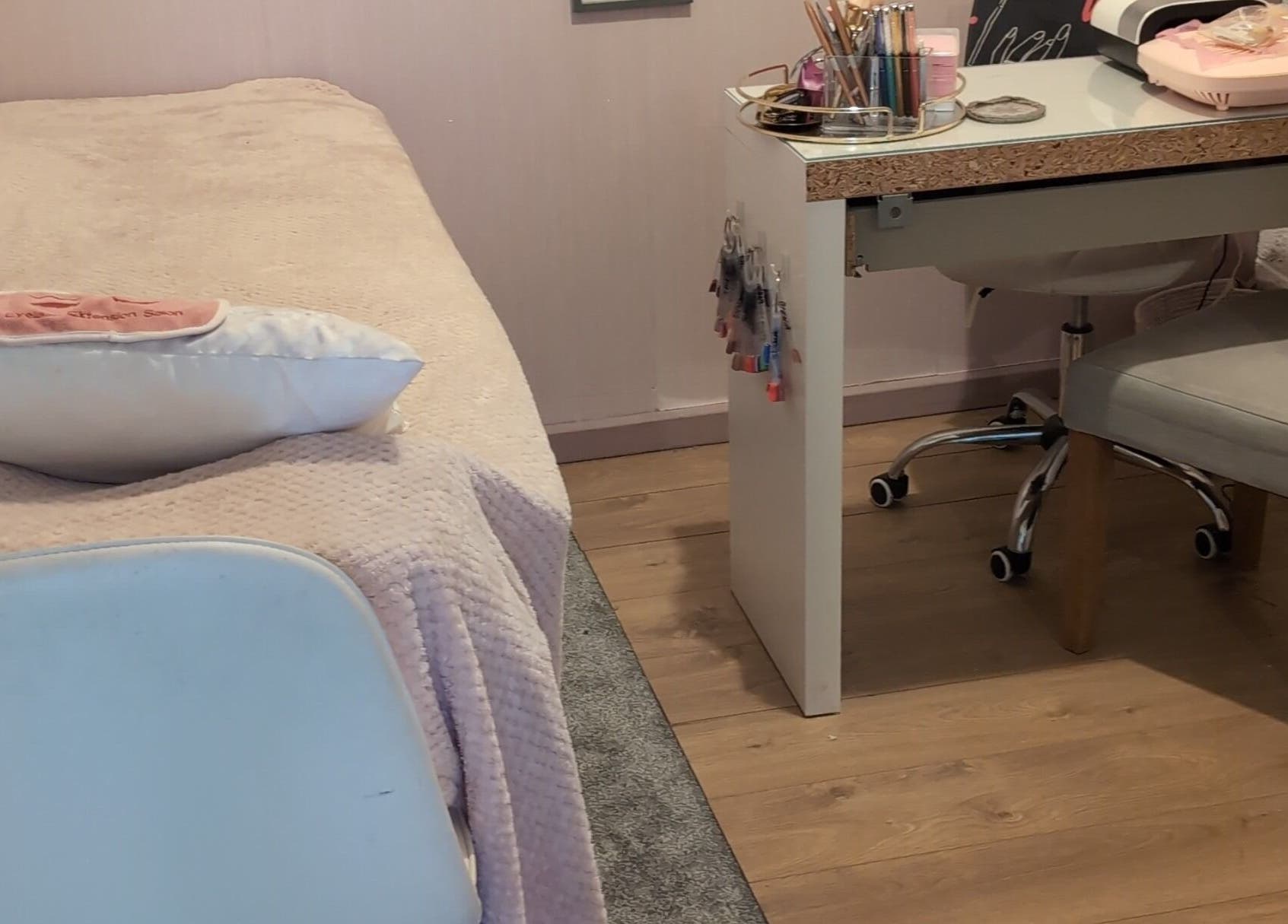 Relaxing treatment area at Halo Hair & Beauty, Nuneaton, England, GB with a plush bed and beauty desk.