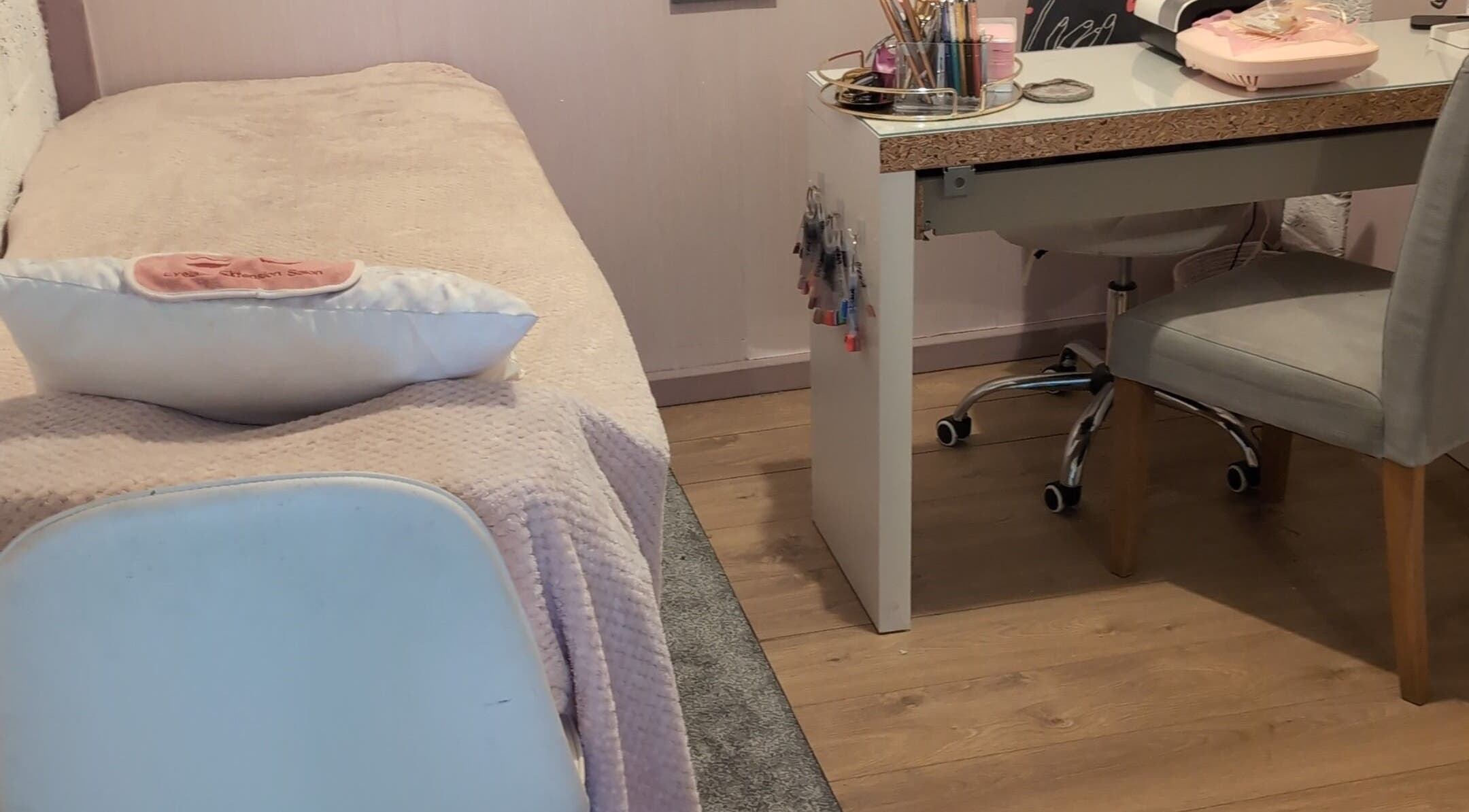 Relaxing treatment area at Halo Hair & Beauty, Nuneaton, England, GB with a plush bed and beauty desk.