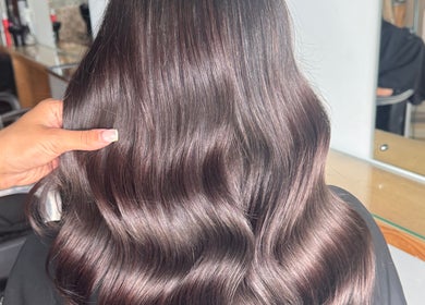Sleek, wavy brown hair styled at Hair by Demi, Blyth, England, GB. A showcase of glossy hair treatment.