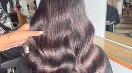 Sleek, wavy brown hair styled at Hair by Demi, Blyth, England, GB. A showcase of glossy hair treatment.
