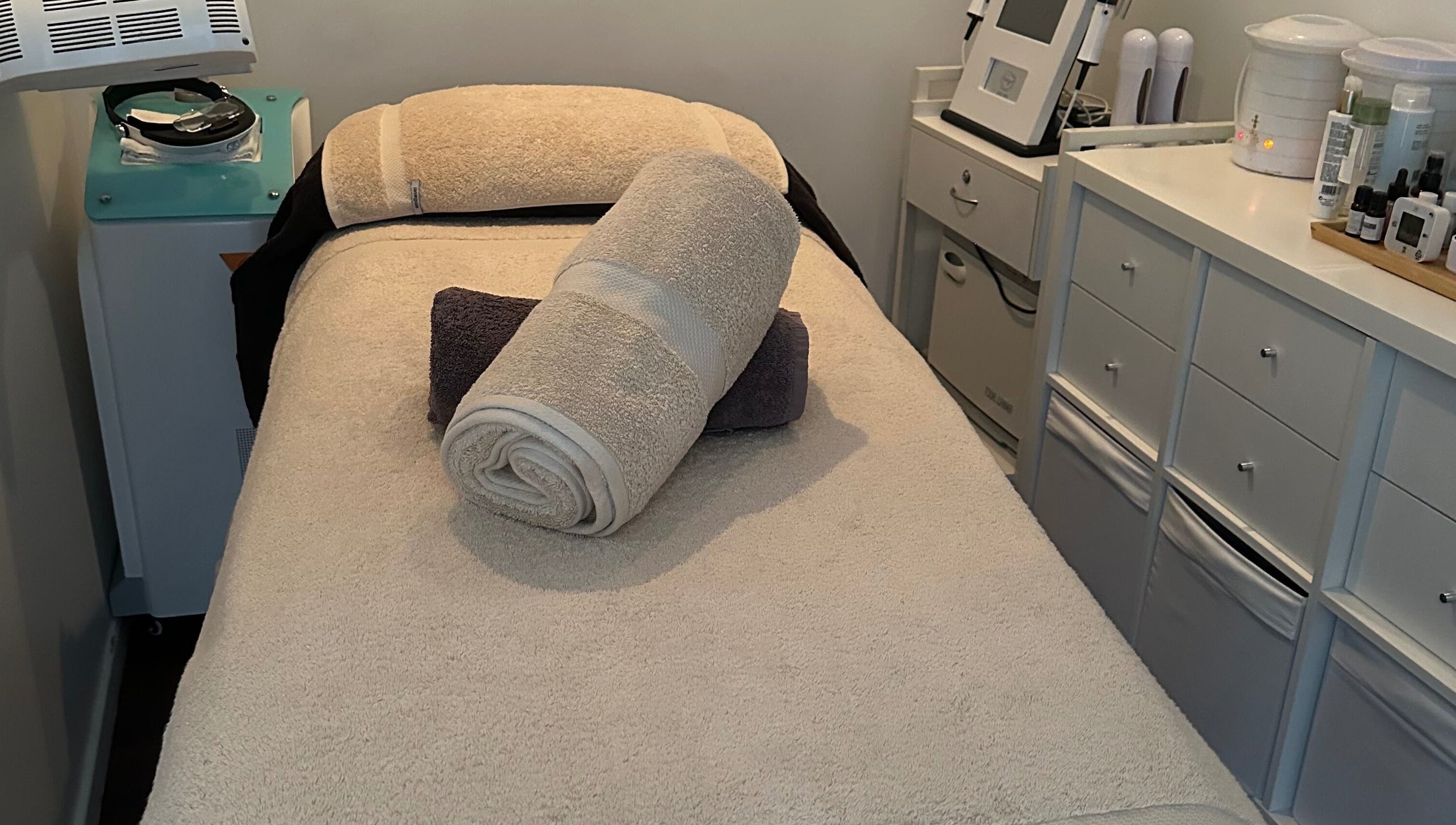 Cozy treatment room at Skinplus, Pymble, New South Wales, AU, showcasing a plush massage table.