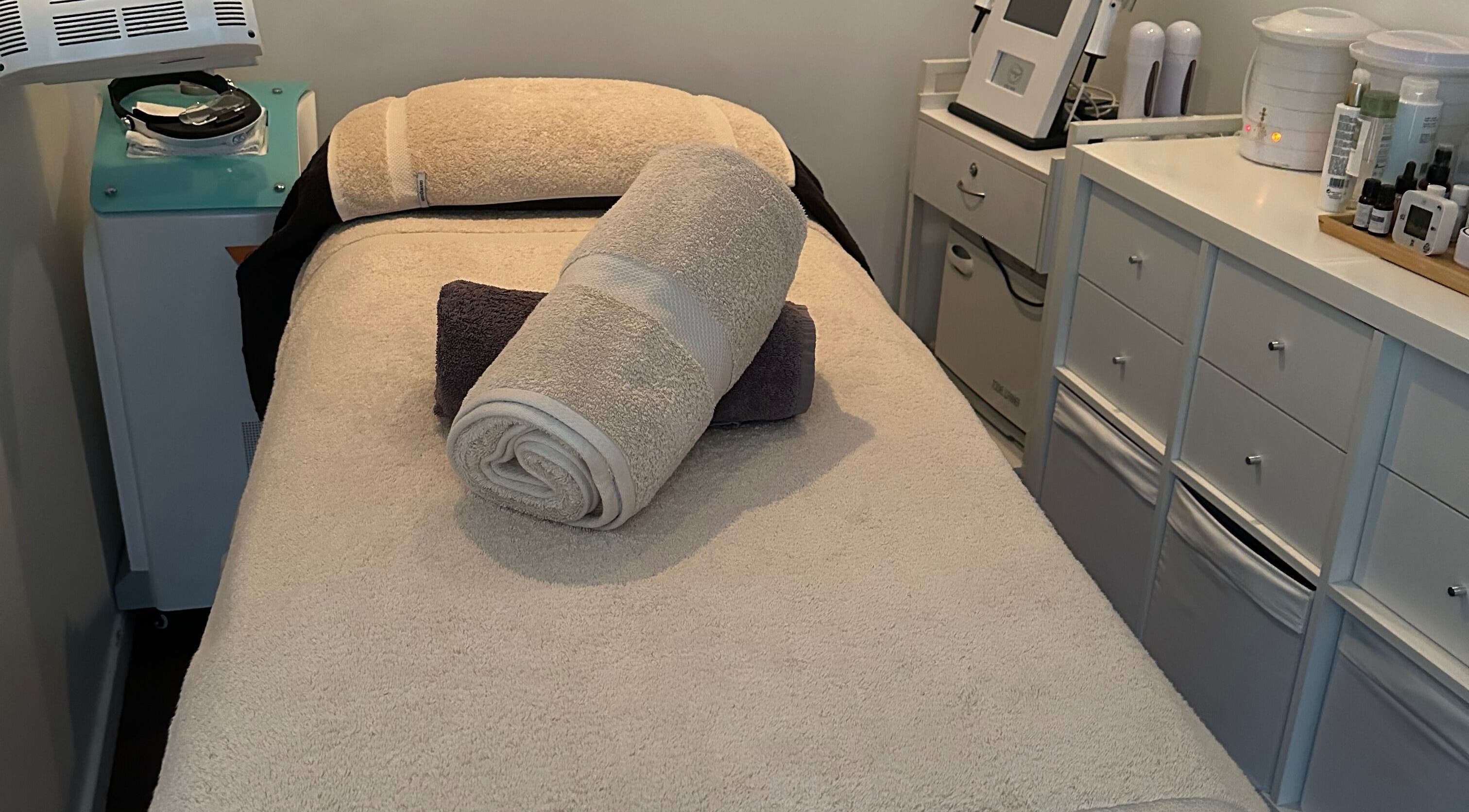 Cozy treatment room at Skinplus, Pymble, New South Wales, AU, showcasing a plush massage table.
