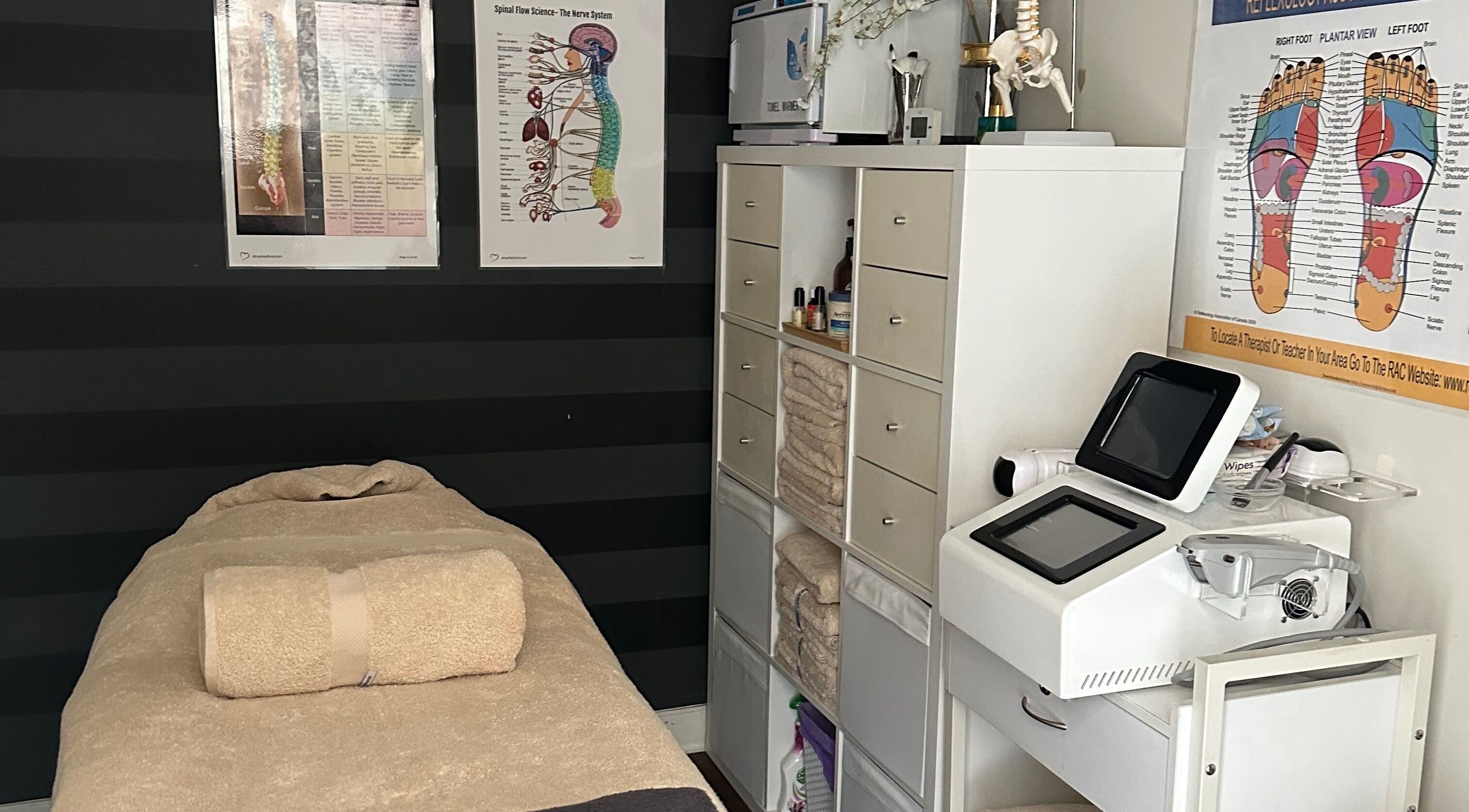 A tranquil massage room at Skinplus, Pymble, New South Wales, AU, featuring a cozy treatment bed and wellness equipment.