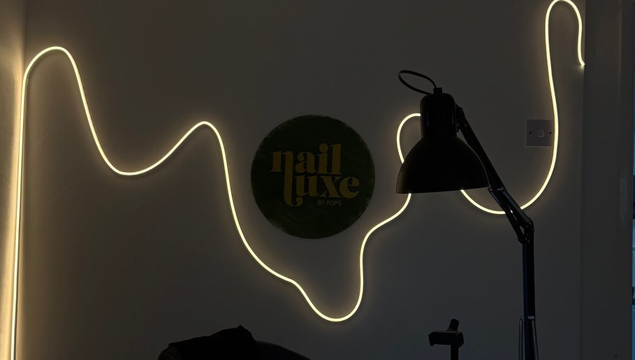 Nail Luxe Nantwich England interior with elegant wall light and decor.