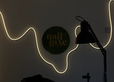 Nail Luxe Nantwich England interior with elegant wall light and decor.