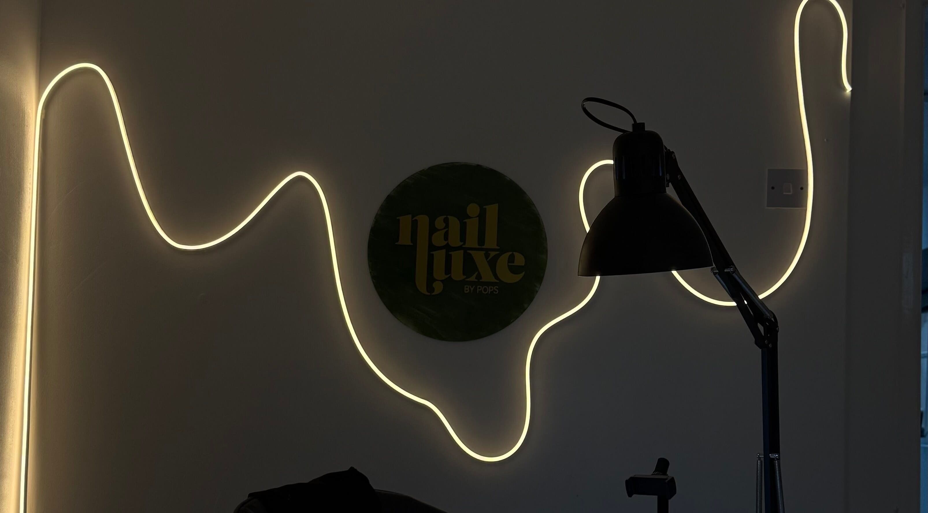 Nail Luxe Nantwich England interior with elegant wall light and decor.