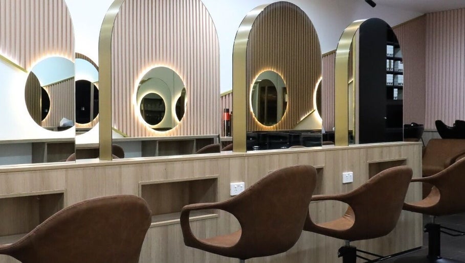 Chic salon interior of W Hair Lounge in Hurstville, New South Wales, AU, featuring stylish mirrors and seating.