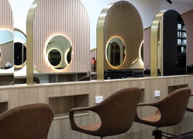 Chic salon interior of W Hair Lounge in Hurstville, New South Wales, AU, featuring stylish mirrors and seating.