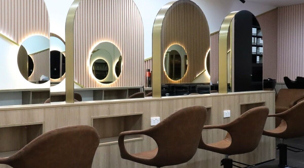 Chic salon interior of W Hair Lounge in Hurstville, New South Wales, AU, featuring stylish mirrors and seating.