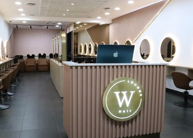 Modern salon interior at W Hair Lounge, Hurstville, New South Wales, AU with sleek design and warm lighting.