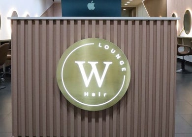 Reception area of W Hair Lounge in Hurstville, New South Wales, AU with modern styling chairs and elegant decor.