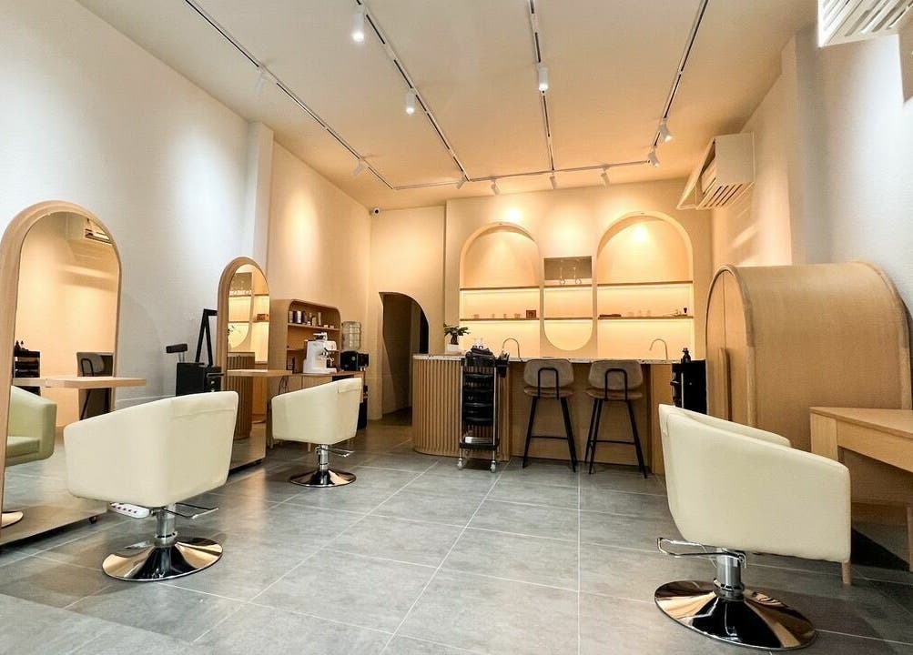 Interior of Gemini Japanese Hair Salon in Hồ Chí Minh, VN, featuring modern styling chairs and elegant decor.