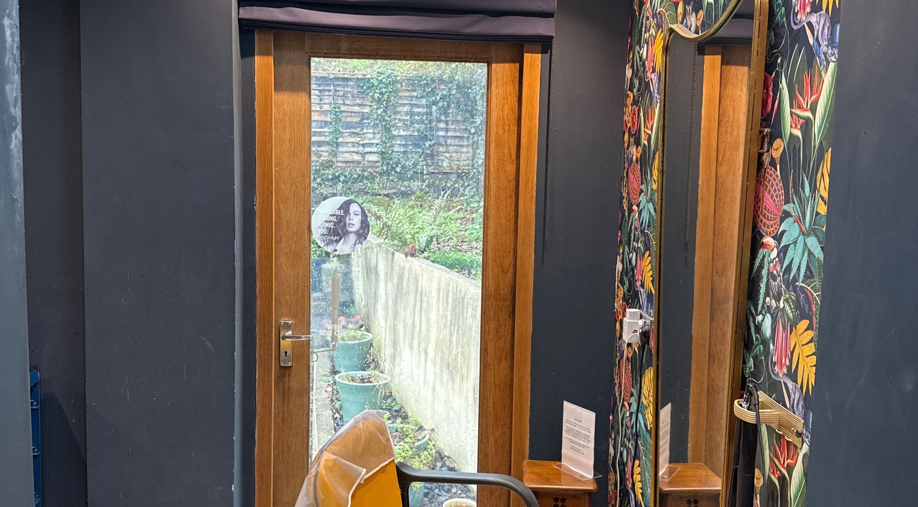 Chic interior of Hush Secret Salon, Bristol, United Kingdom, GB with vibrant wall decor and garden view.