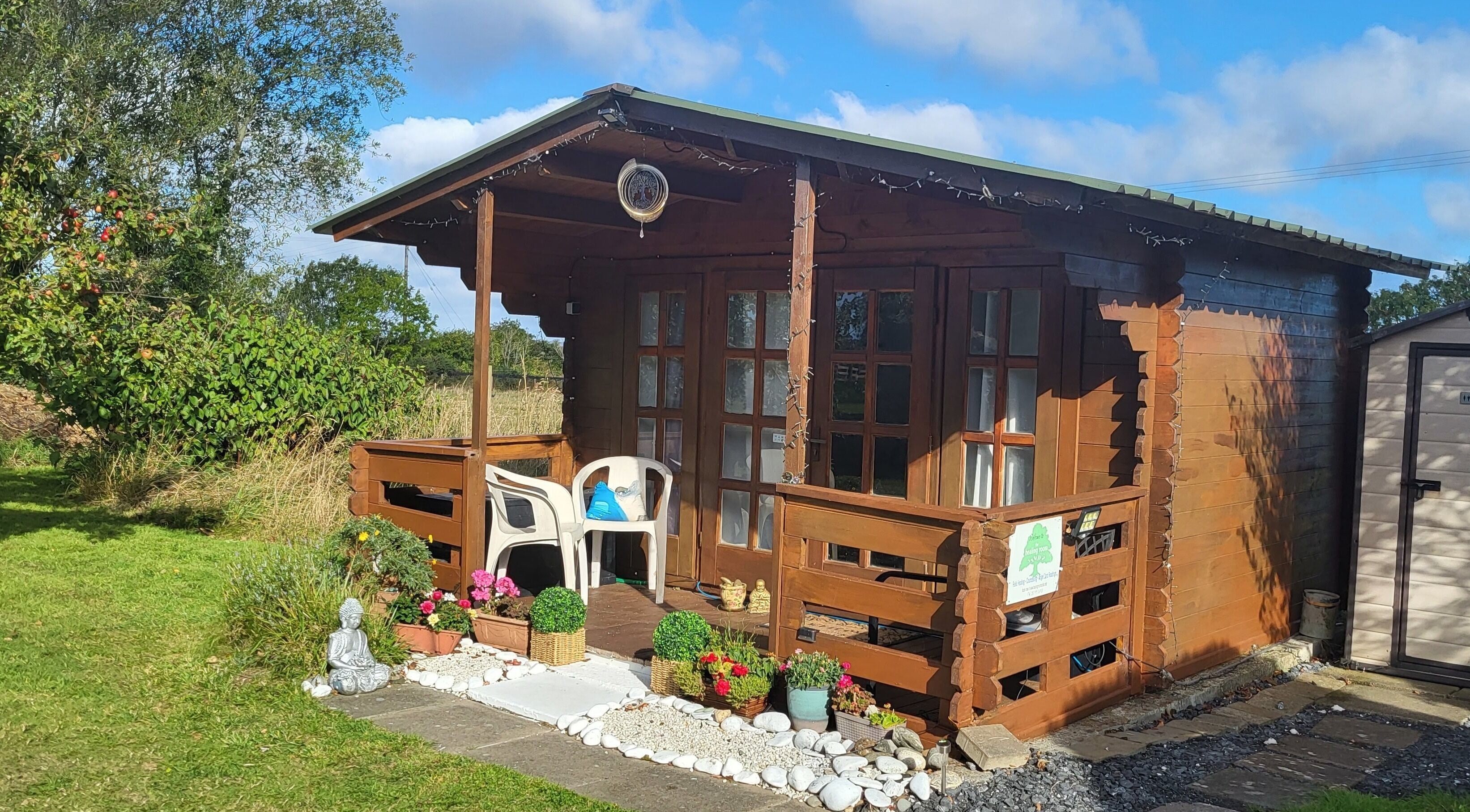 Charming wooden cabin at The Healing Room in Dublin, Dublin, IE surrounded by lush greenery.