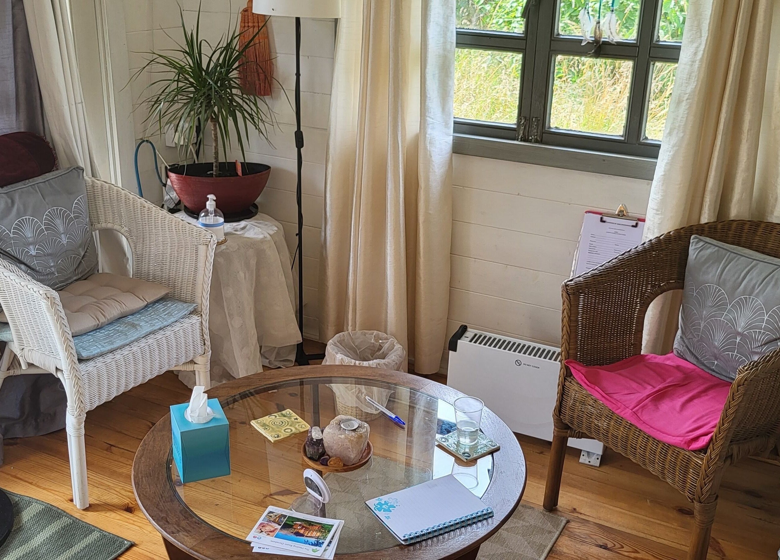 Cozy seating area at The Healing Room, Dublin, Dublin, IE, with wicker chairs and calming decor.