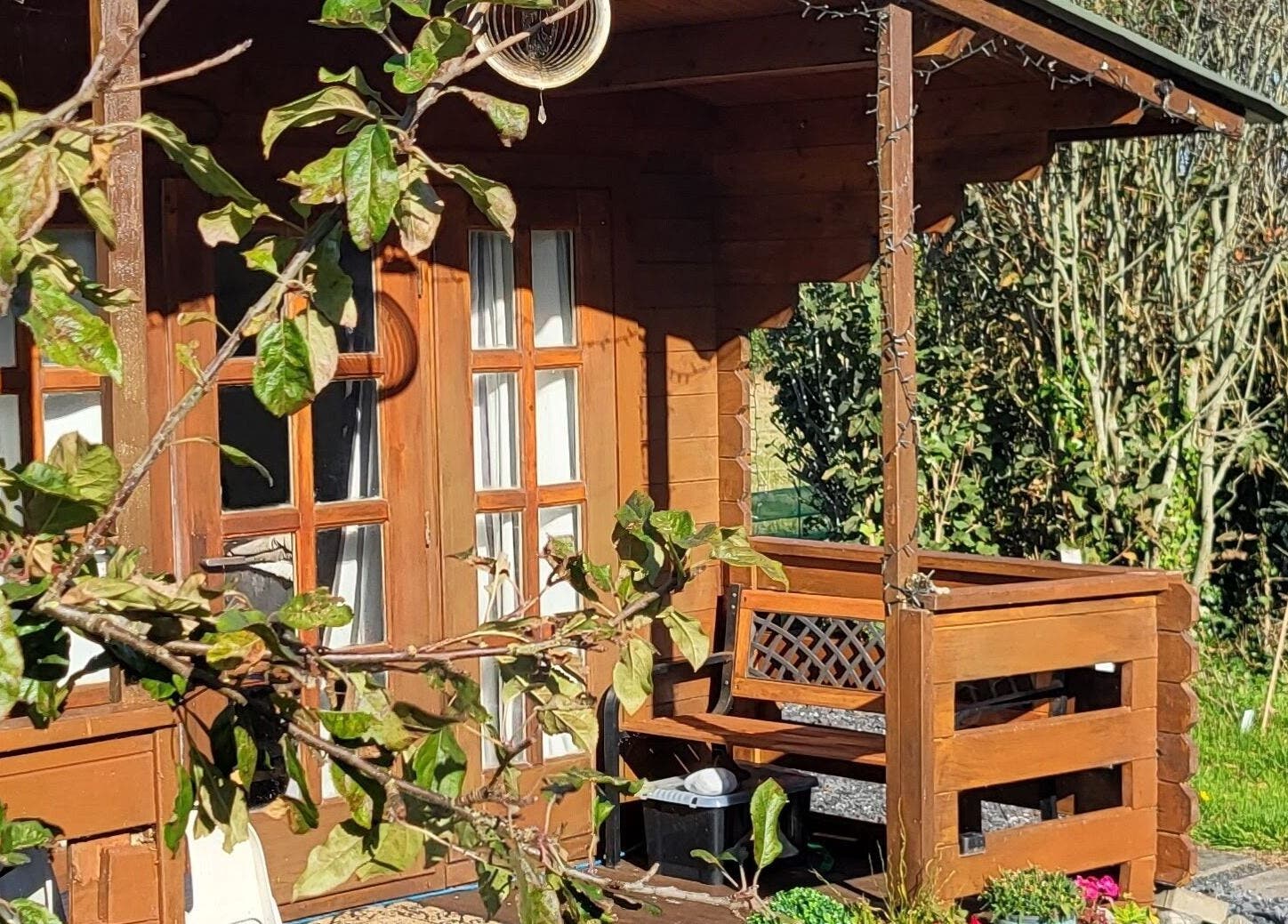 Charming wooden porch at The Healing Room, Dublin, Dublin, IE, surrounded by lush greenery.