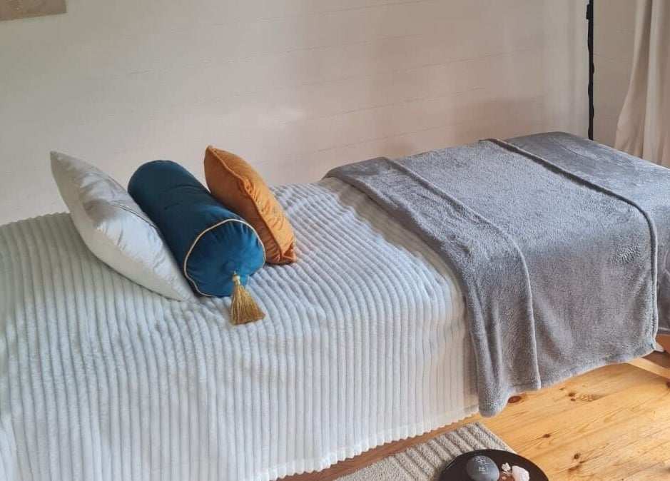 Relaxing massage table setup at The Healing Room, Dublin, Dublin, IE with plush pillows and soft blankets.