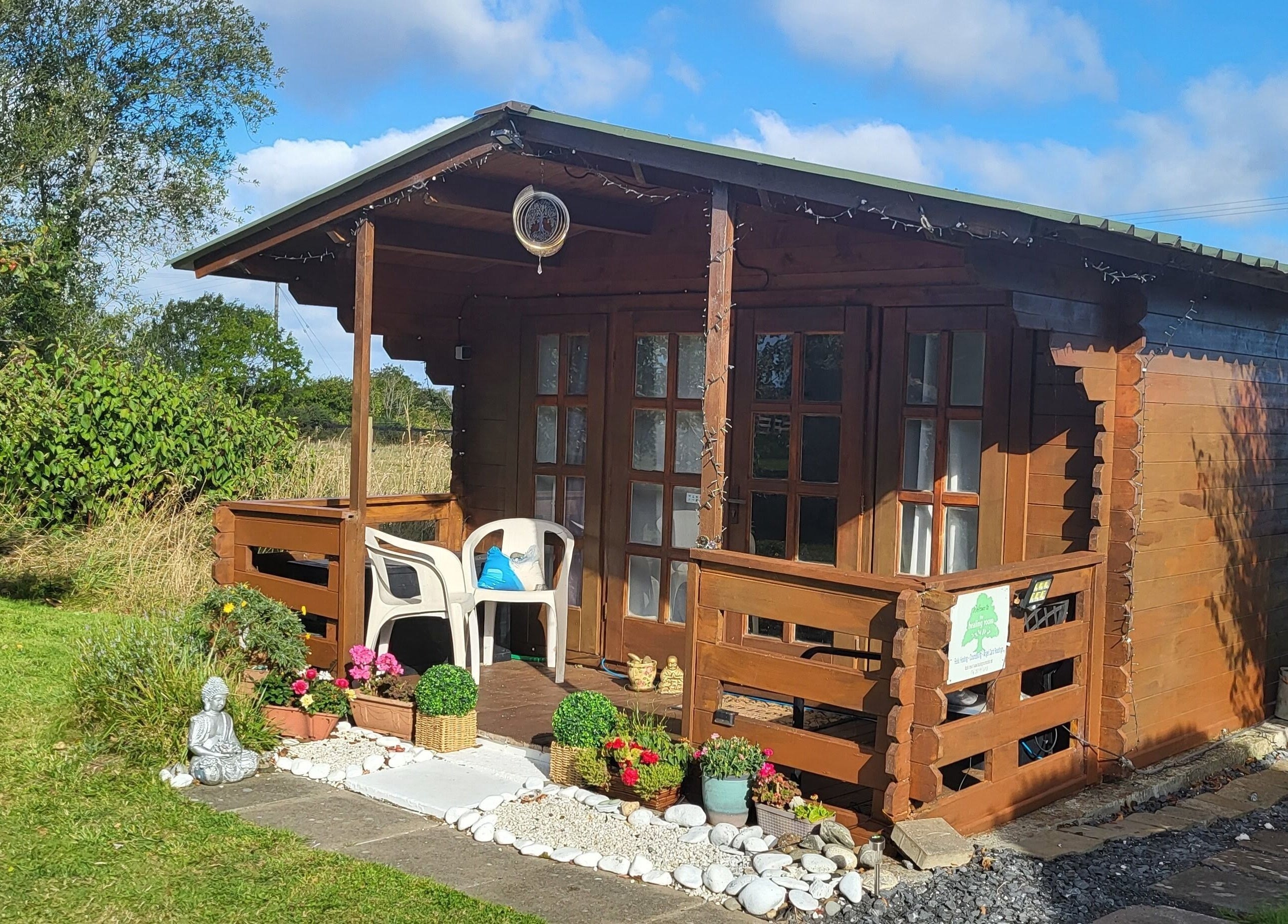 Charming wooden cabin at The Healing Room, Dublin, Dublin, IE, surrounded by greenery and decorations.