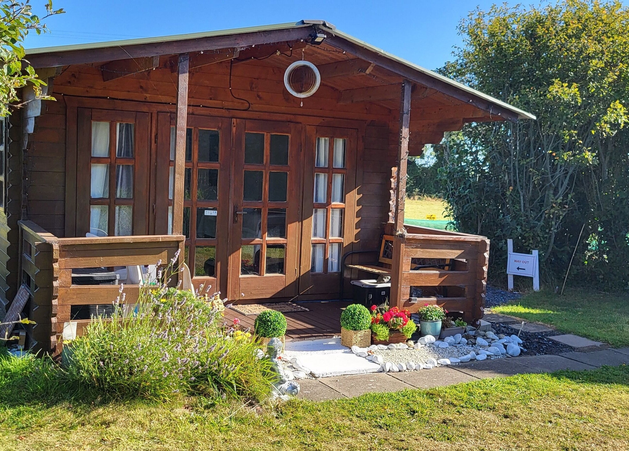 Rustic cabin exterior at The Healing Room, Dublin, Dublin, IE, surrounded by lush greenery.