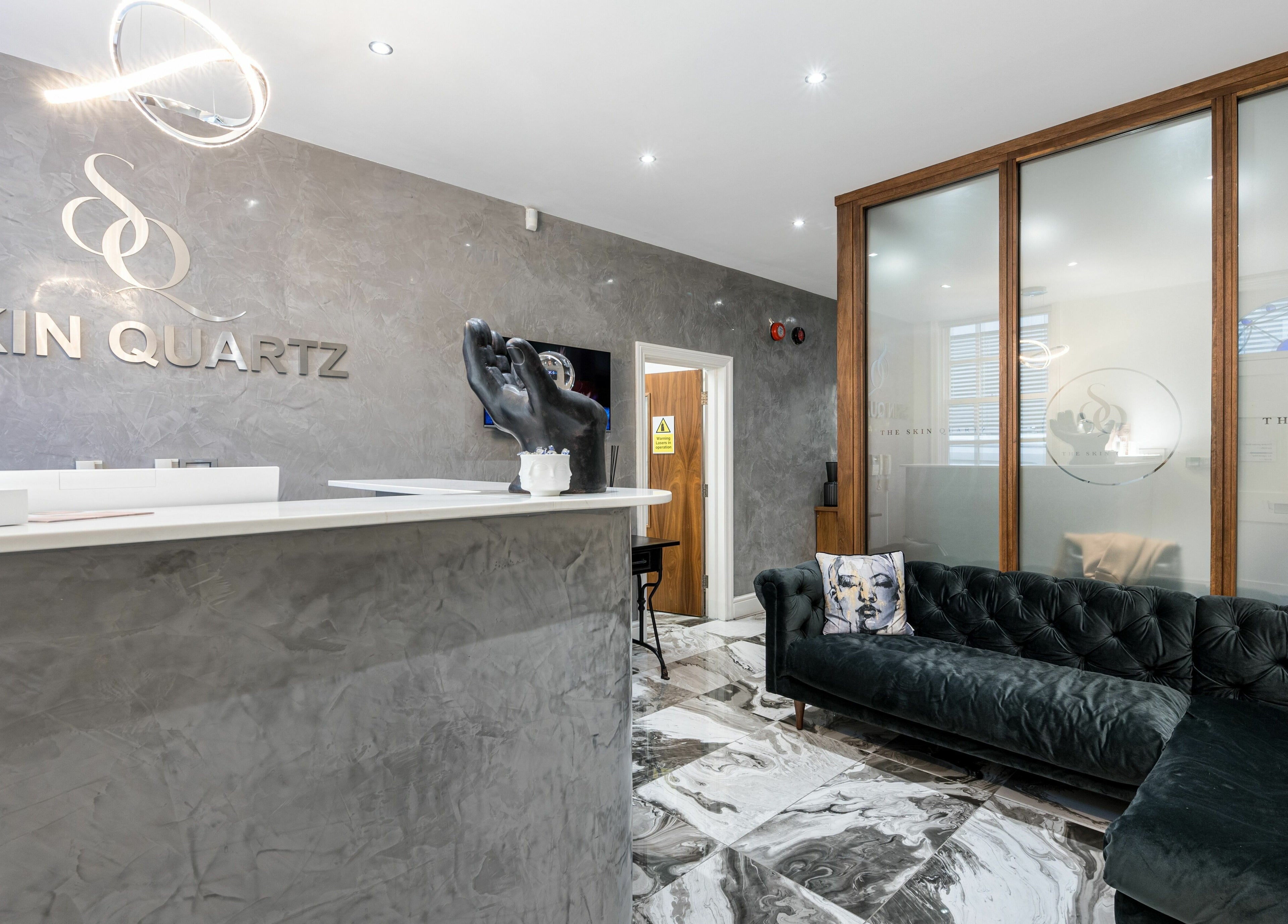 Reception area of The Skin Quartz in Manchester, England, GB, featuring a stylish sofa and modern decor.