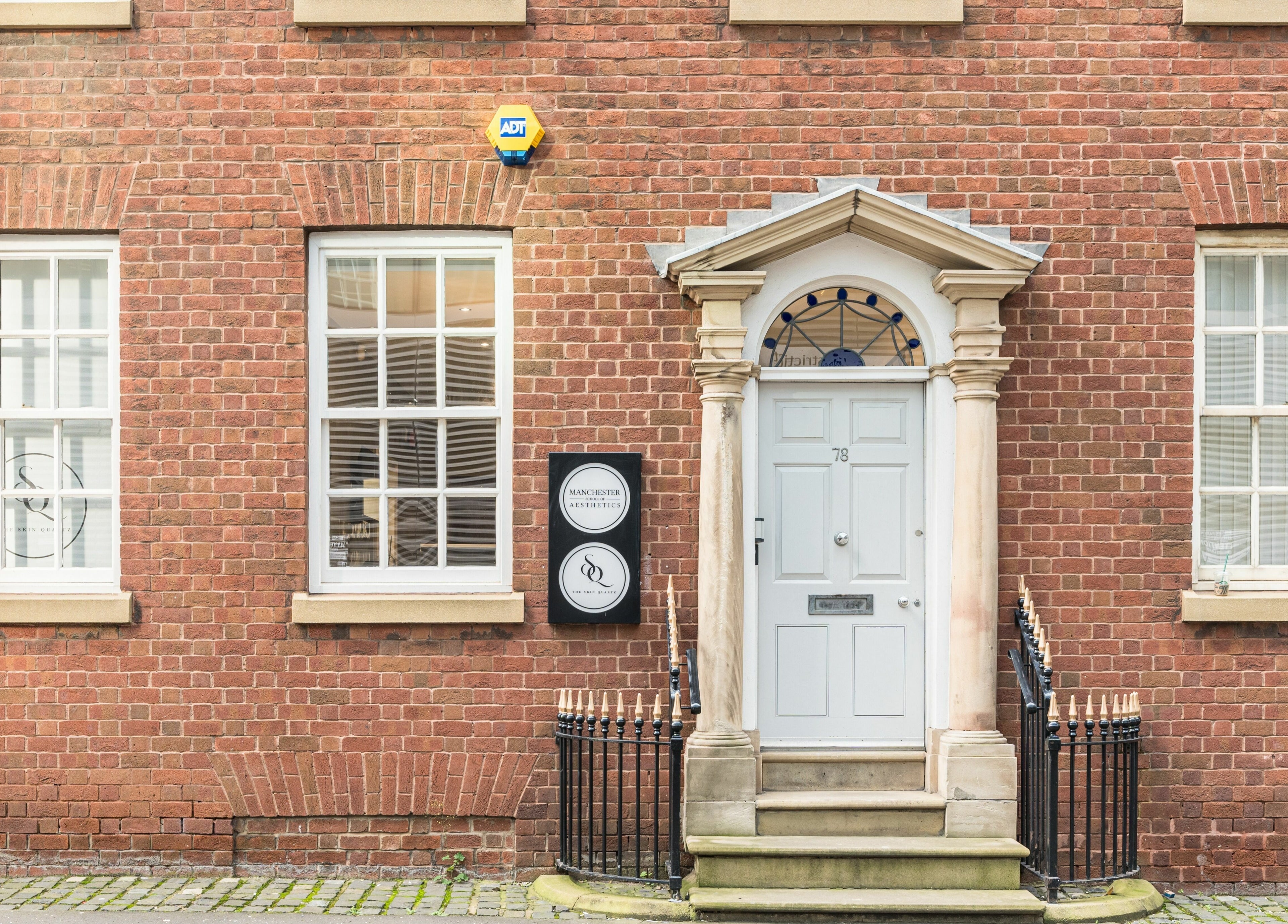 Front view of The Skin Quartz in Manchester, England, GB, showcasing a classic brick exterior with windows.