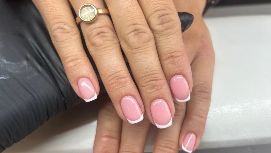 Elegant French manicure at Fiona Watton Beauty, Bude, England, GB, showcasing glossy pink nails with white tips.