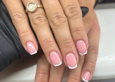 Elegant French manicure at Fiona Watton Beauty, Bude, England, GB, showcasing glossy pink nails with white tips.